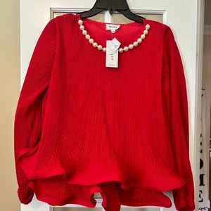 New! Pearls beaded around the neck, a beautiful red shirt, a statement piece!